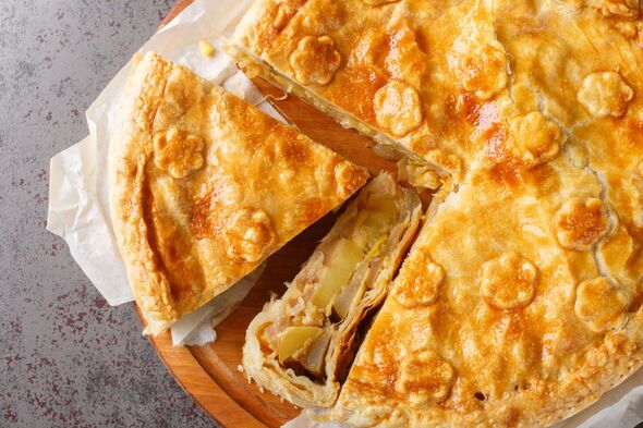 Ingredients laid out for leek and potato pie recipe – leeks, potatoes, butter, milk, and puff pastry.